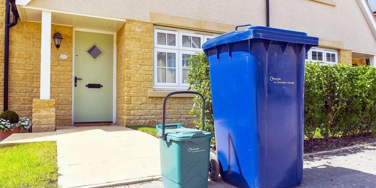 Image shows: Bins outside a house ready for collection on a residential street