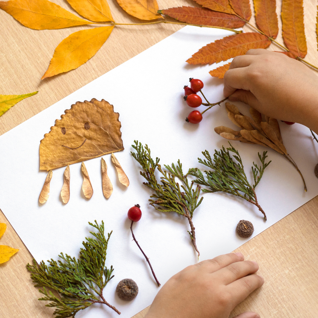 Autumn craft with a child placing the dry leaves