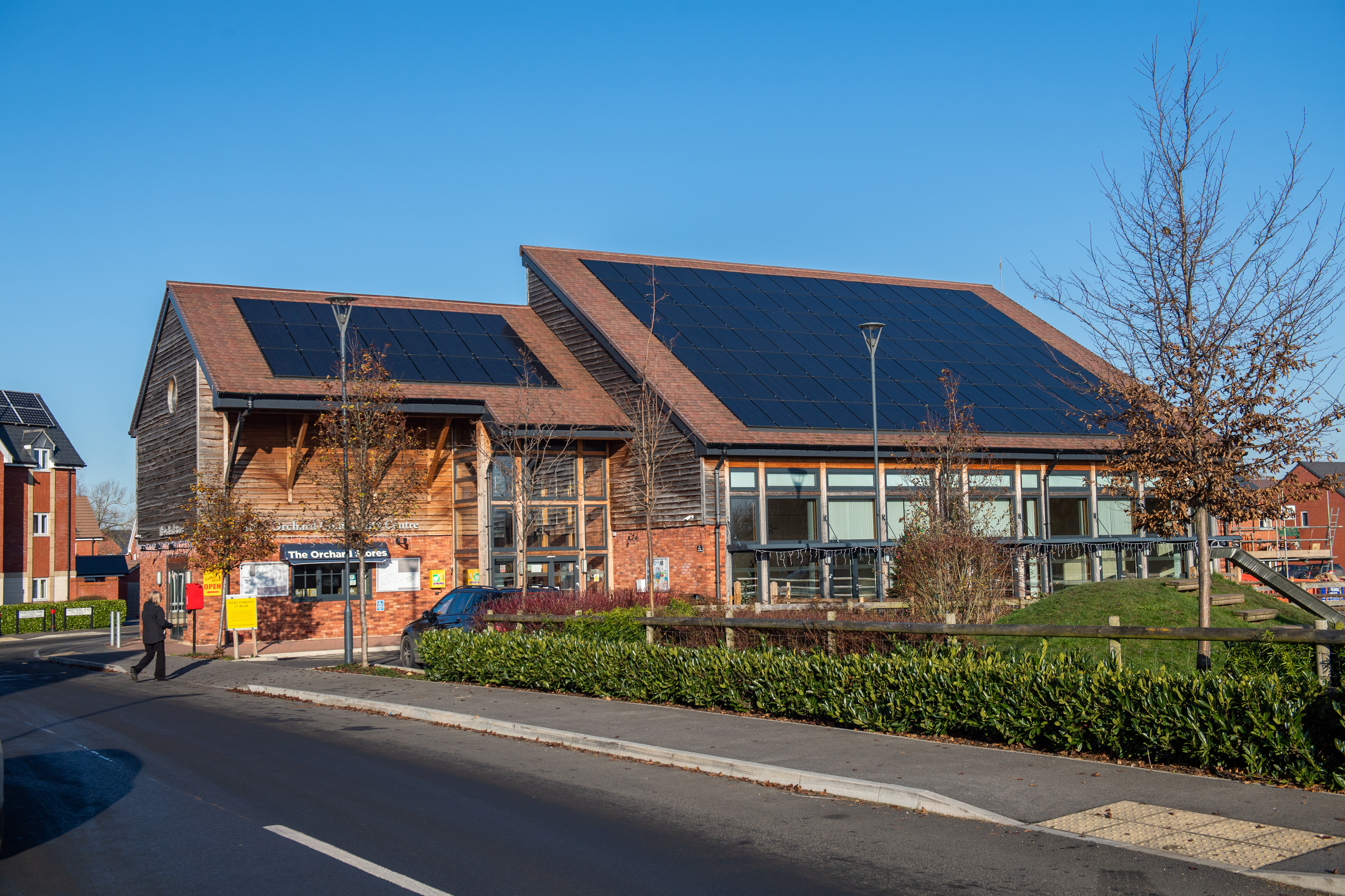 Solar panels on community centre on a bright sunny day with clear blue skies