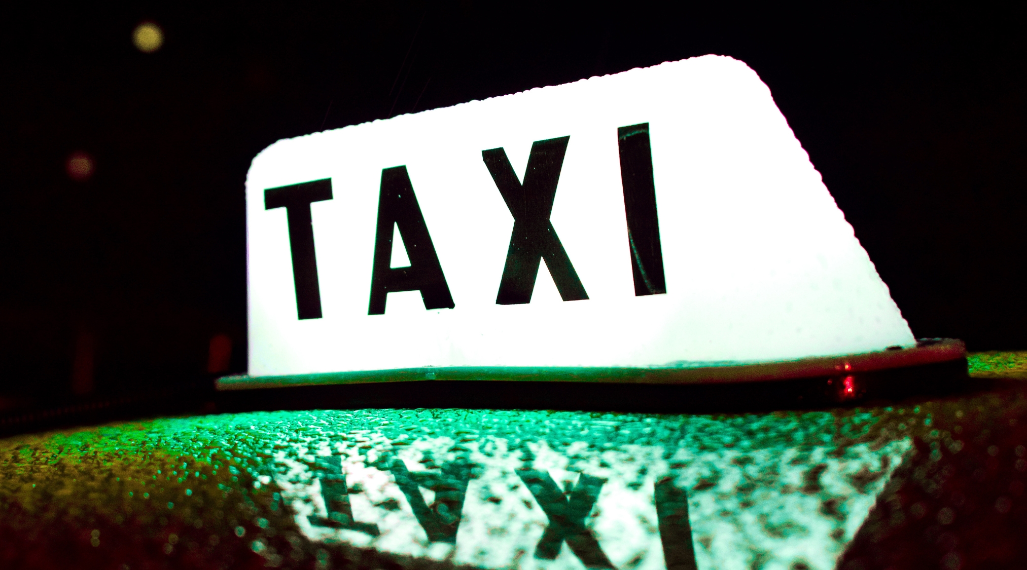 Image showing a taxi sign lit up at night