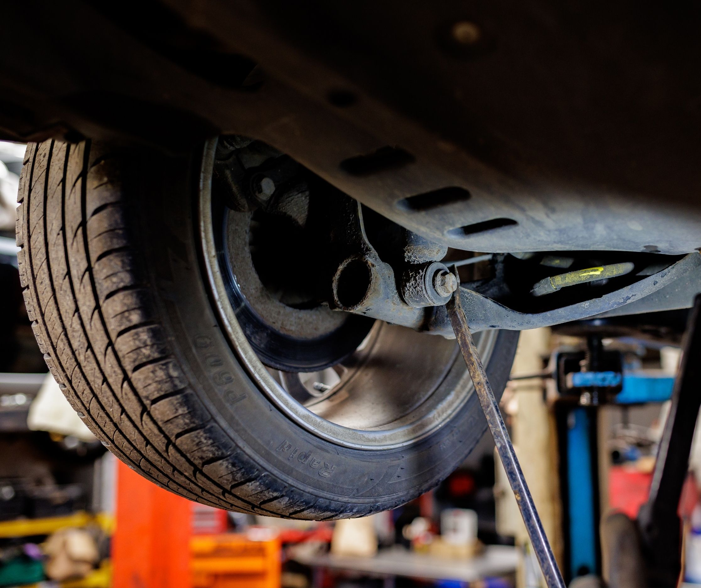 Close up of a car on a service ramp at an MOT testing station.