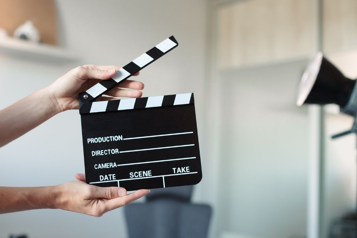 Photo with a mock up of a film set with a clapper board and lighting