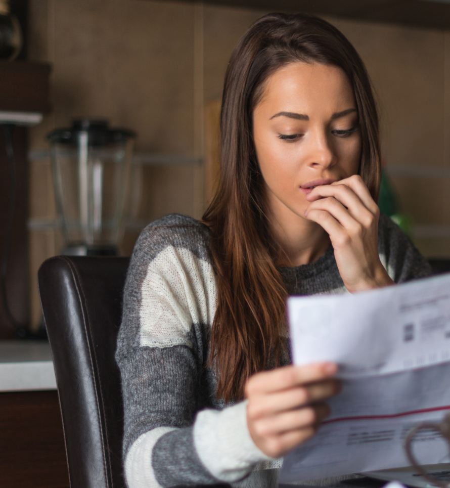a woman looks at a piece of paper